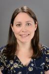A photo of Heather Yarger in front of a gray background 