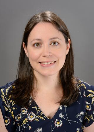 A photo of Heather Yarger in front of a gray background