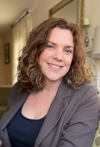 Dr. Jennifer Wessel facing and smiling at the camera, wearing a navy top and grey blazer.